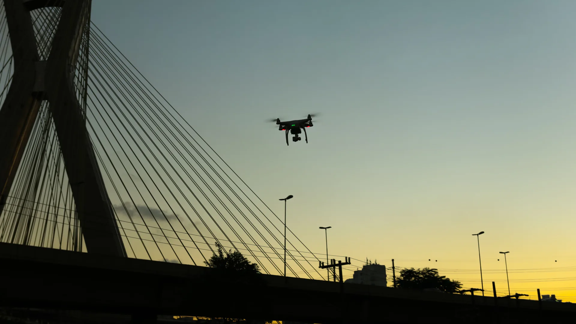 Small drone approaching an industrial site protected by a layered counter-UAS architecture
