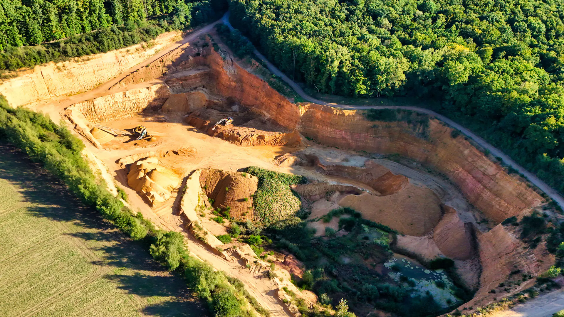 Remote industrial worksite where access terrain and exclusion zones shape a heavy-lift drone mission