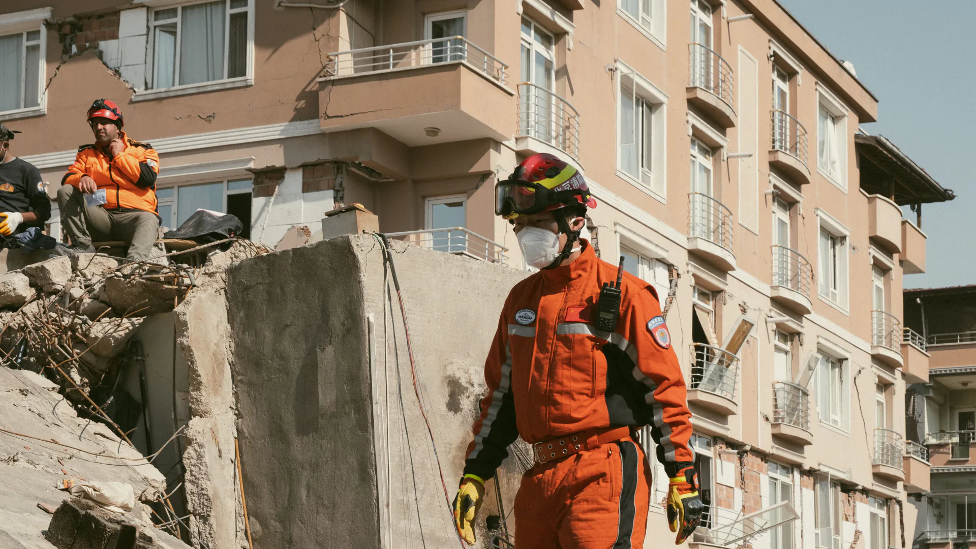 Authorized rescue personnel working around a concrete building during a public-safety search