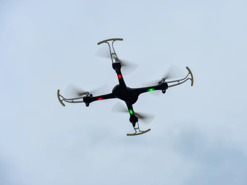 Drone operating after dark where task-light placement must remain separate from required aircraft conspicuity lighting