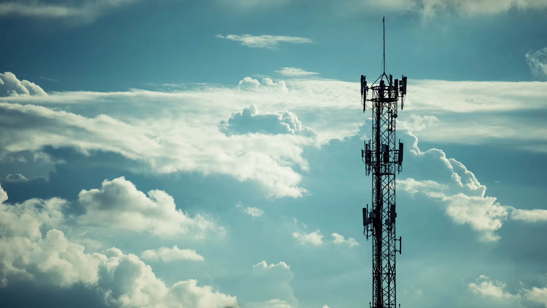 Telecommunications tower rising above open terrain where a drone inspection must account for RF exposure and asset identity
