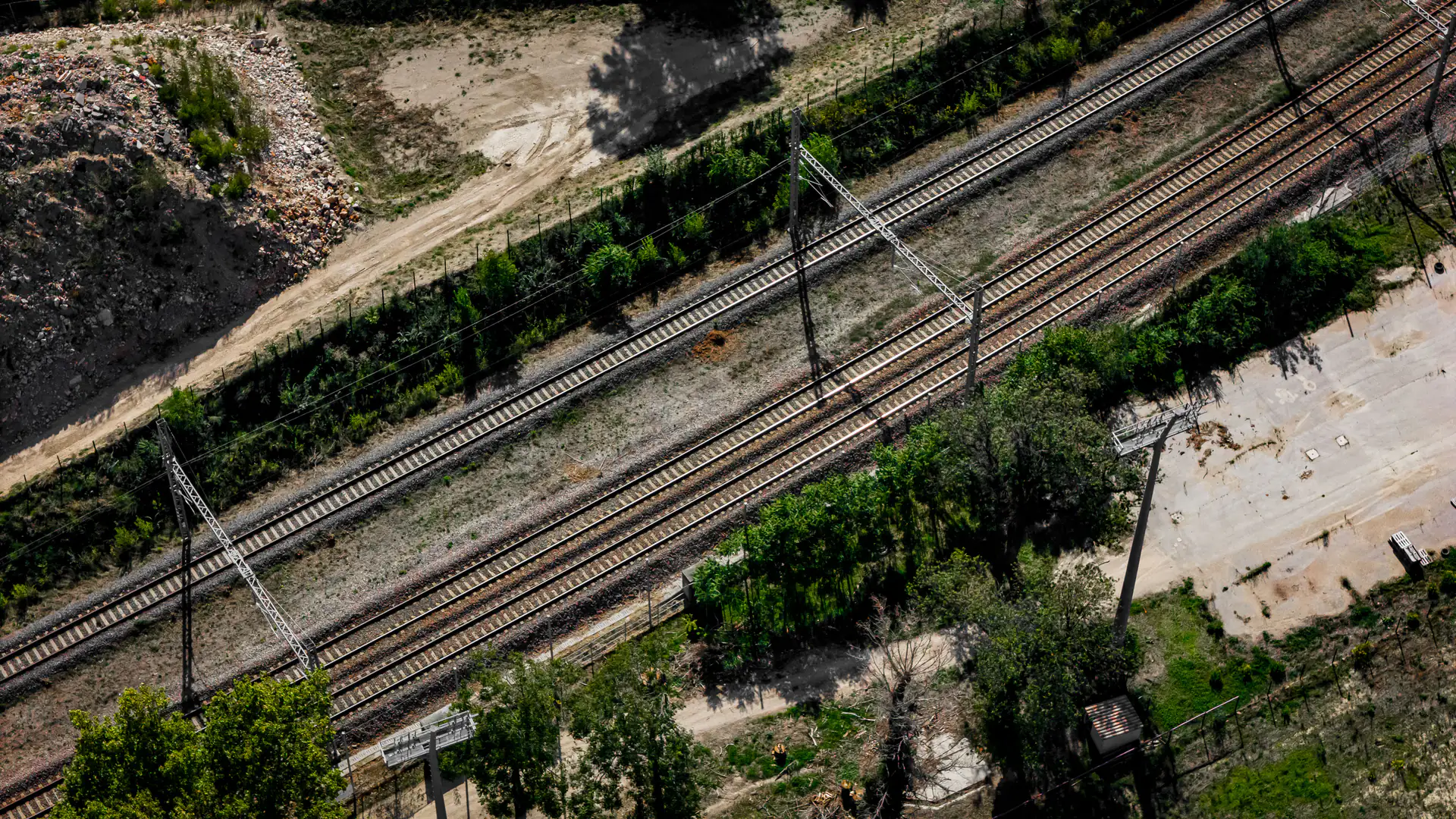 Rail corridor crossing open terrain where a drone inspection plan must preserve chainage and track identity