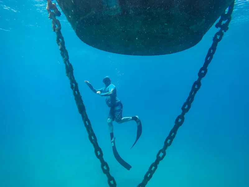 Diver working underwater where unresolved ROV observations may require tactile verification or engineering assessment
