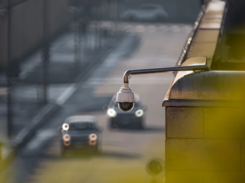 Roadside traffic camera overlooking highway lanes where direction sensing must remain separate from simple presence detection