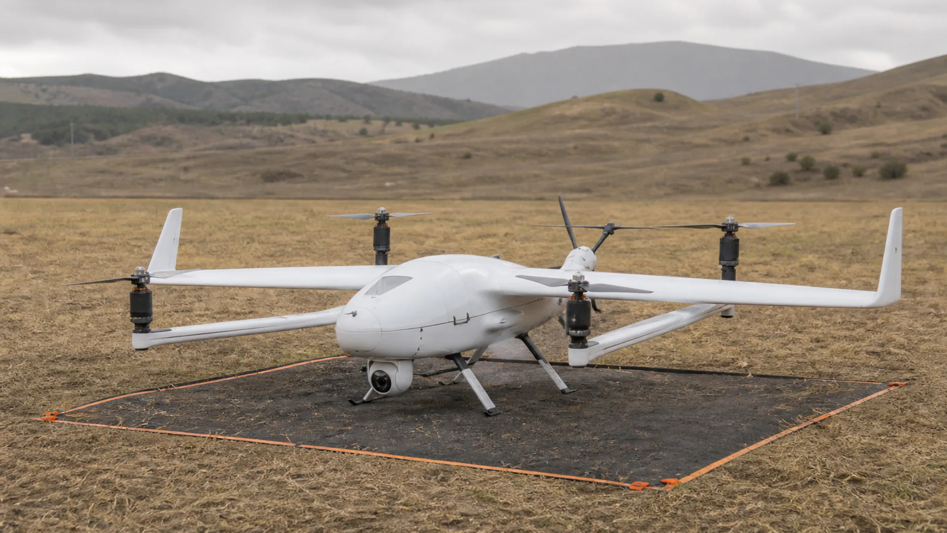 VTOL fixed-wing mapping drone prepared on a marked field launch area for an acceptance mission