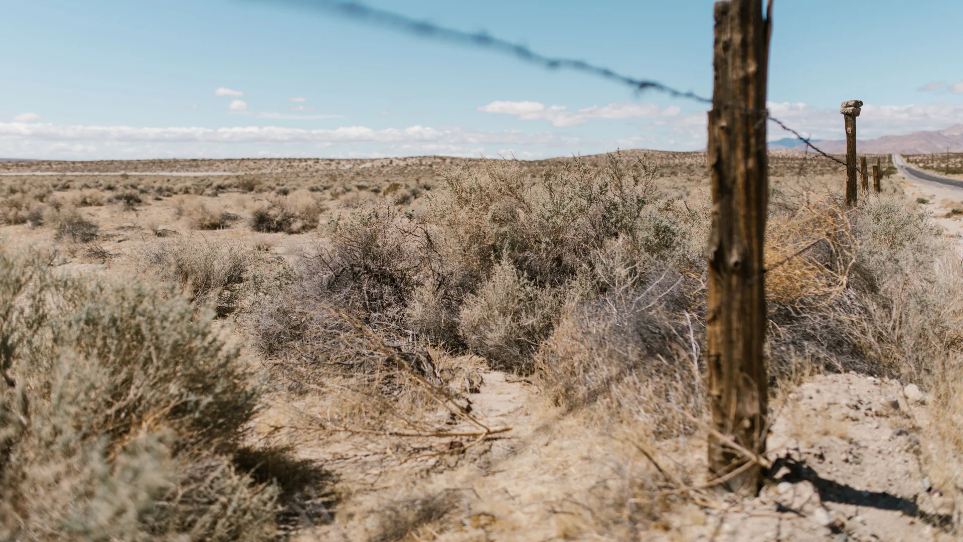 Remote border terrain viewed from a surveillance position where radar coverage must follow the land