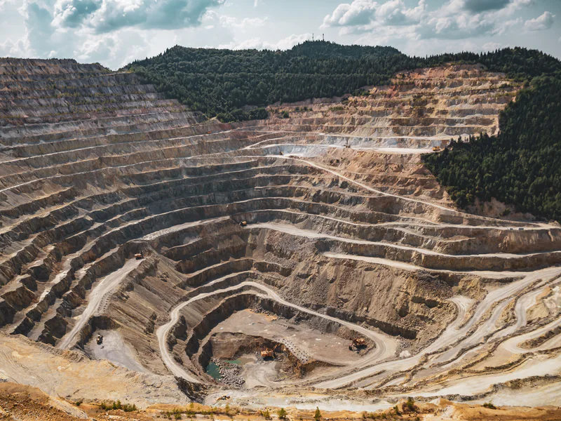Layered mine highwall terrain requiring standoff inspection and careful aerial route planning